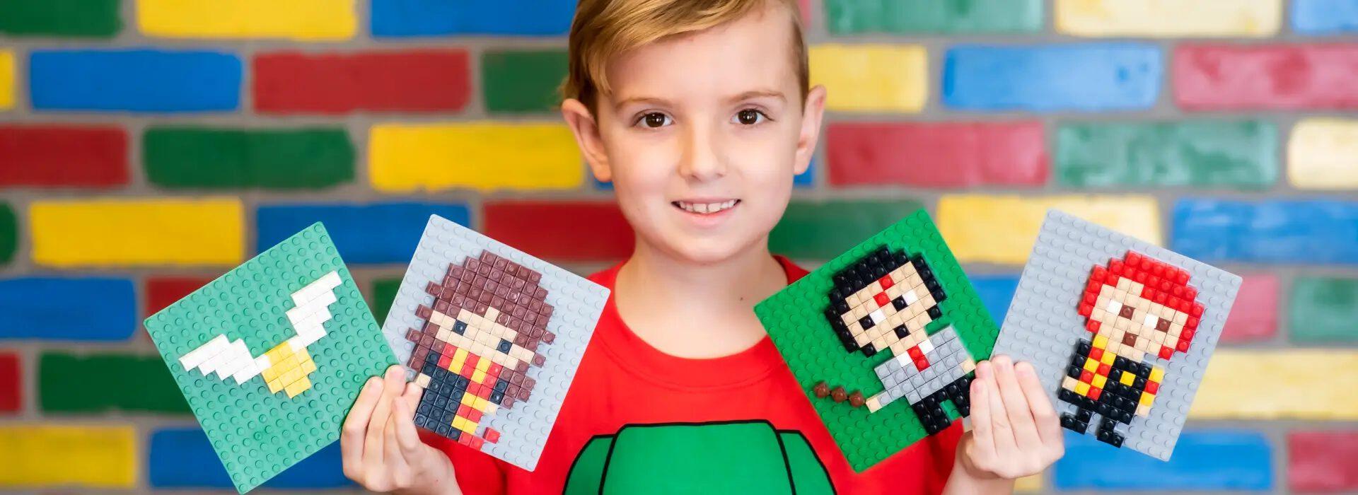A young builder showing pixel-art mosaics made from bricks