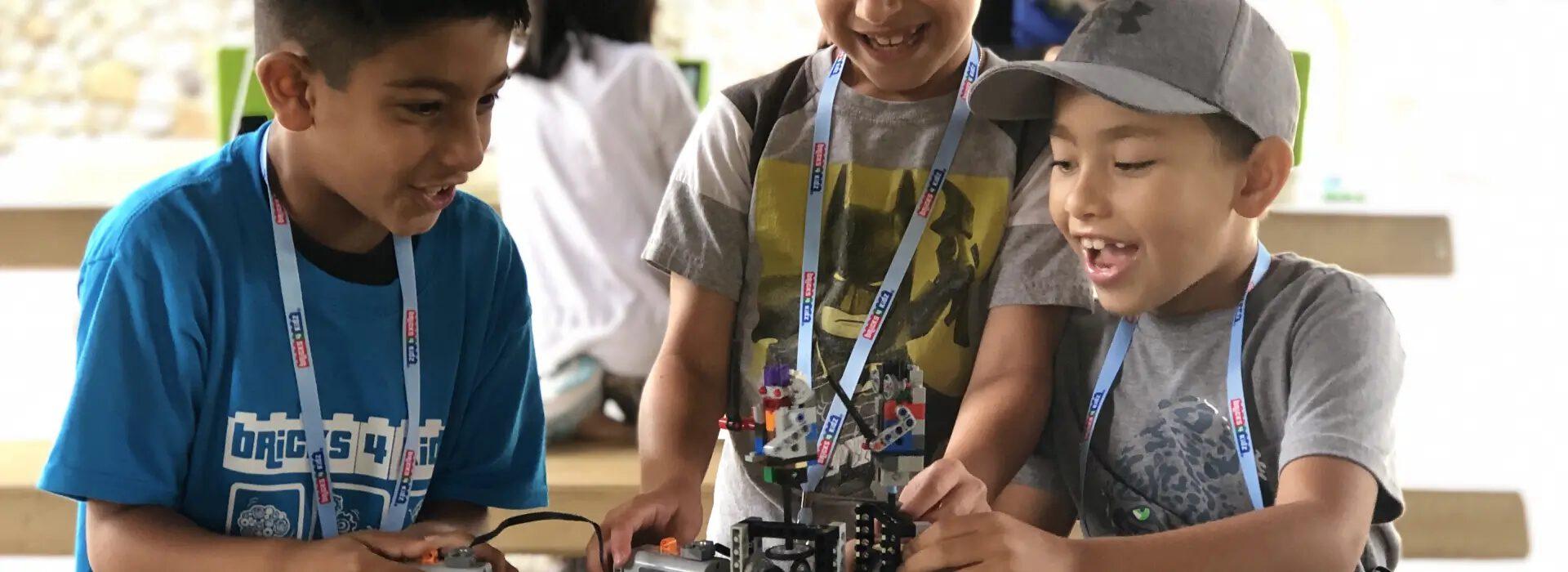 Students building and programming robots during a Bricks 4 Kidz class